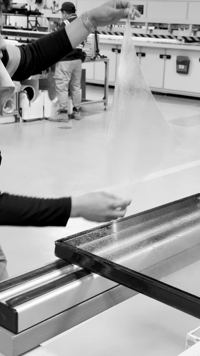 Fortis R&D — hand-lamination of PET film onto glass, Ljubljana facility