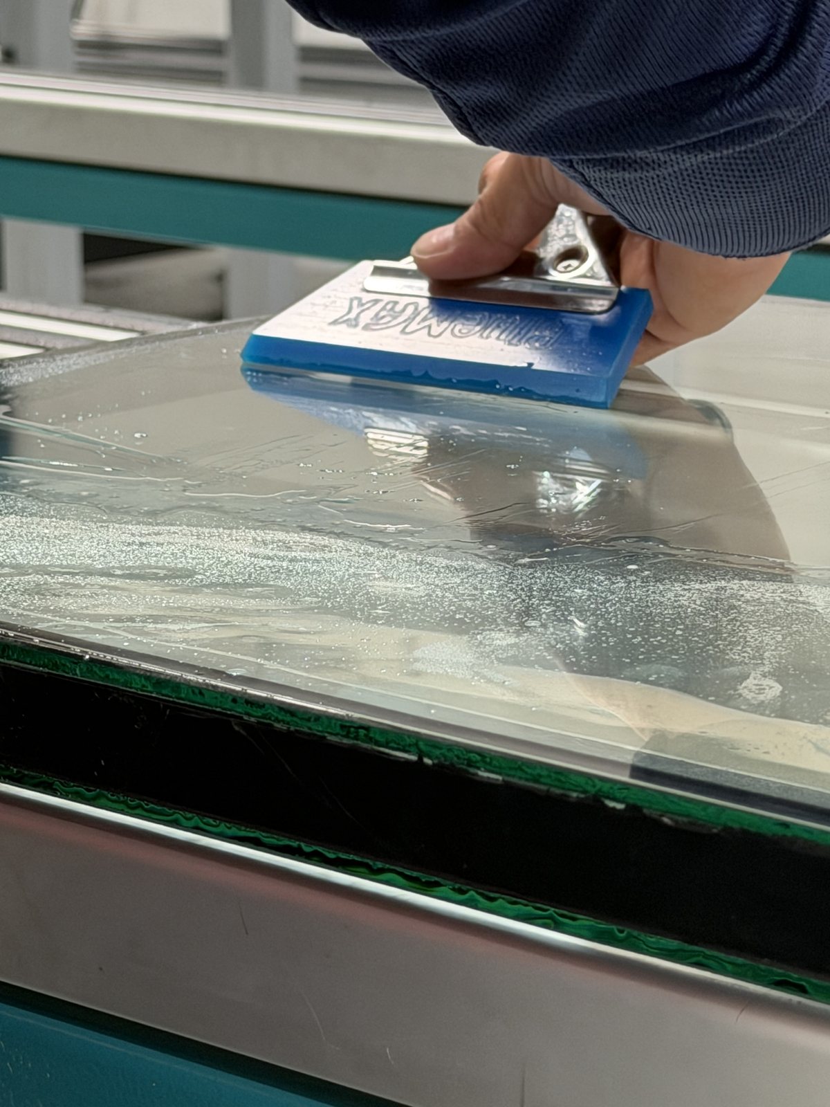 Fortis technician laminating a ballistic glass panel