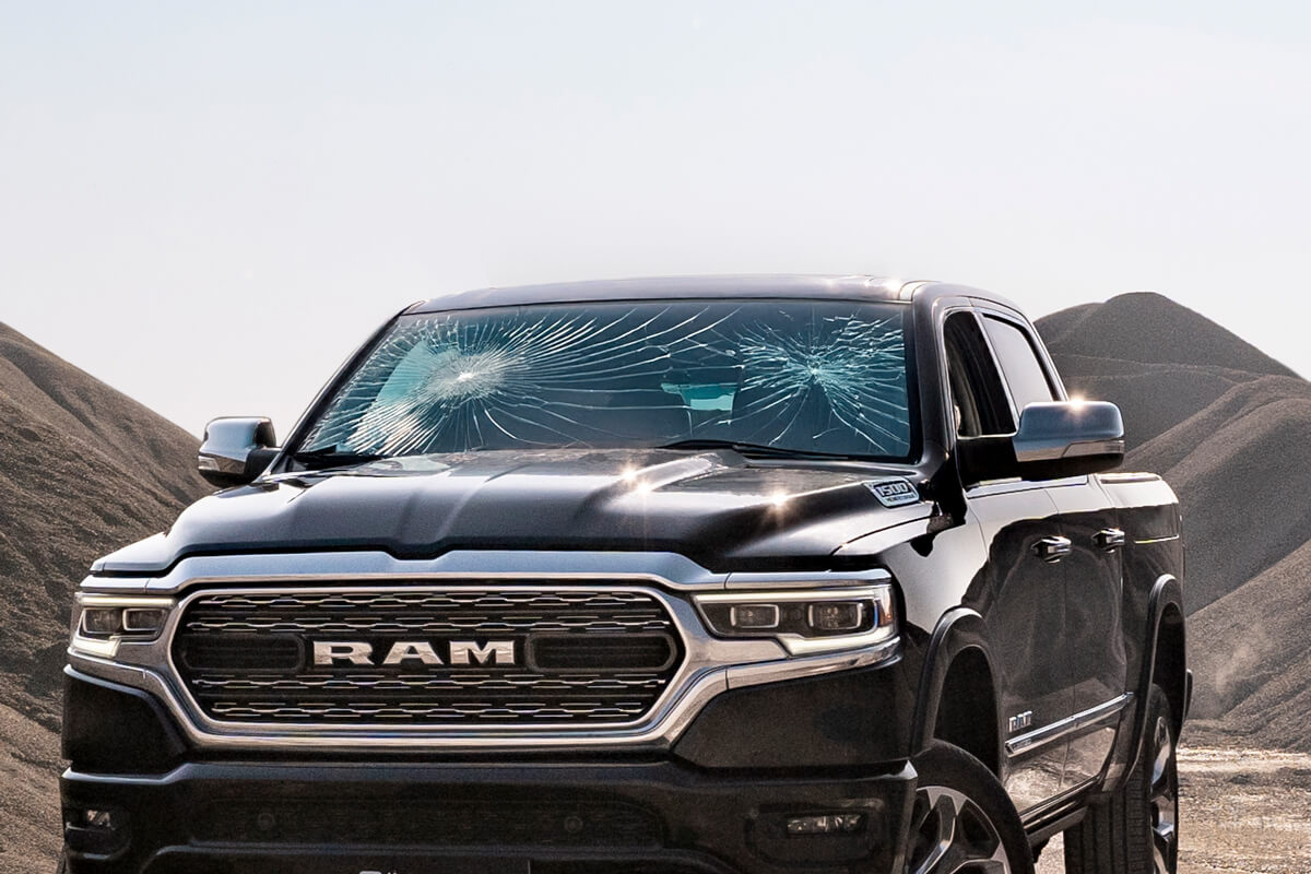 Vehicle glass after high-calibre ballistic impact — Fortis-protected panel remains intact