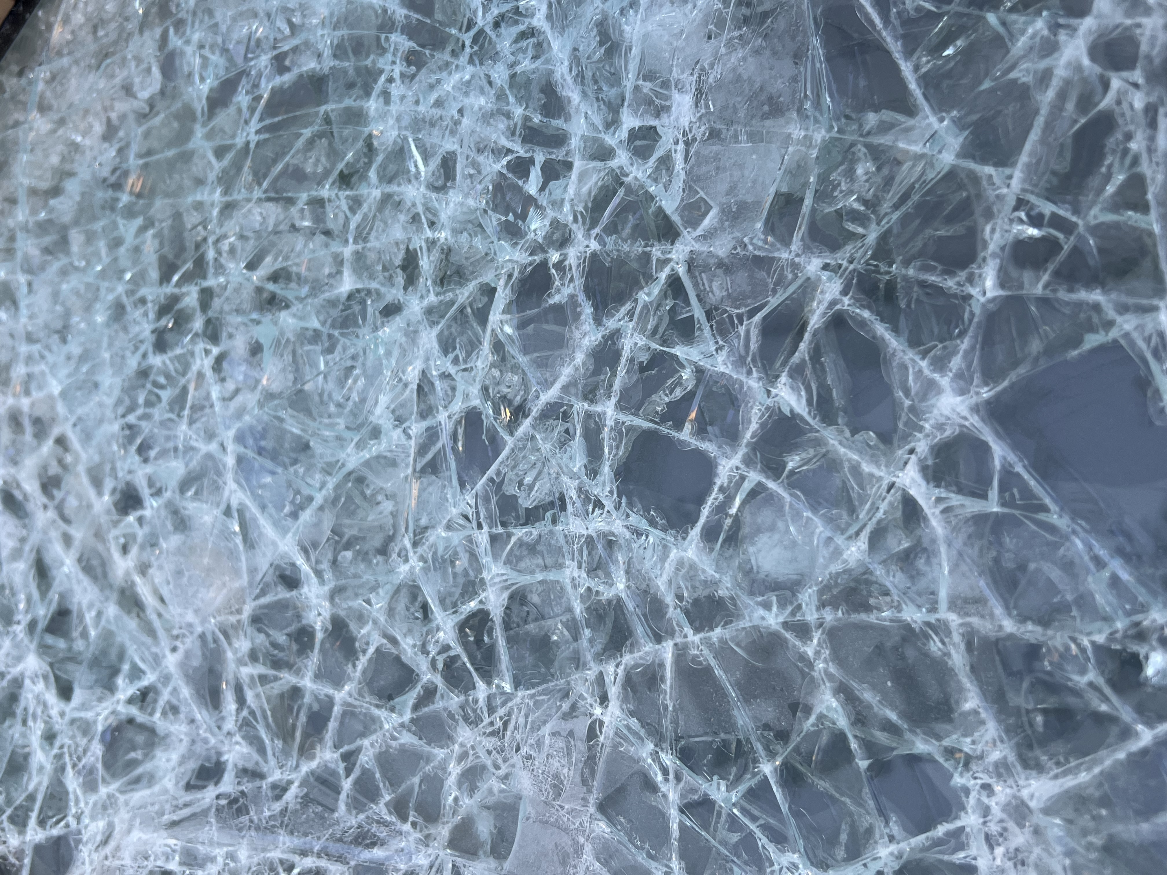 Unprotected glass completely shattered after ballistic impact — Fortis solution comparison